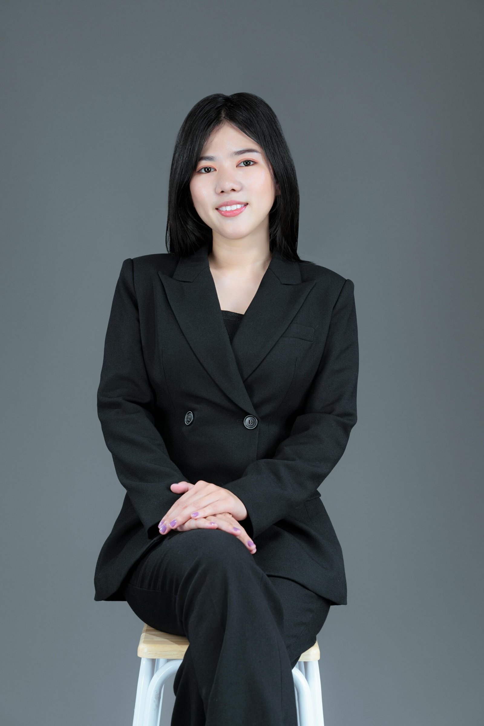 Professional female recruiter sitting confidently, representing talent acquisition and hiring expertise.